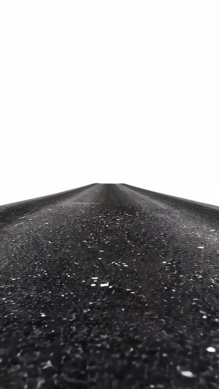 A road with a sharp pointy end. The road is empty and the sky is white Vertical video
