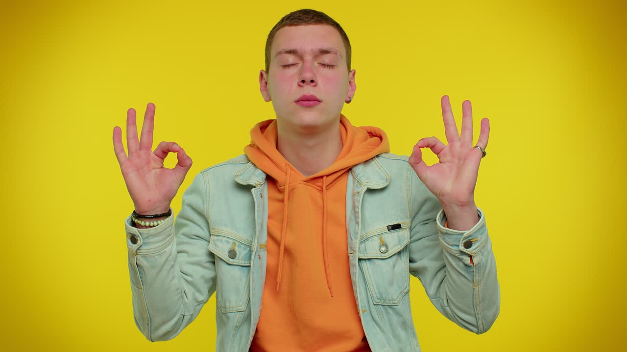 세련된 남자는 무드라 몸짓으로 깊이 숨을 쉬고, 집중된 생각과 평화로운 마음으로 명상합니다.