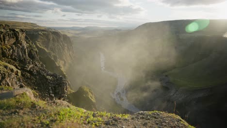 Breathtaking-cinematic-panoramic-shot-of-green-cliffs-with-a-river-running-through-the-center