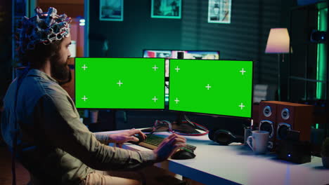 Computer-engineer-starting-mind-upload-process-using-green-screen-PC