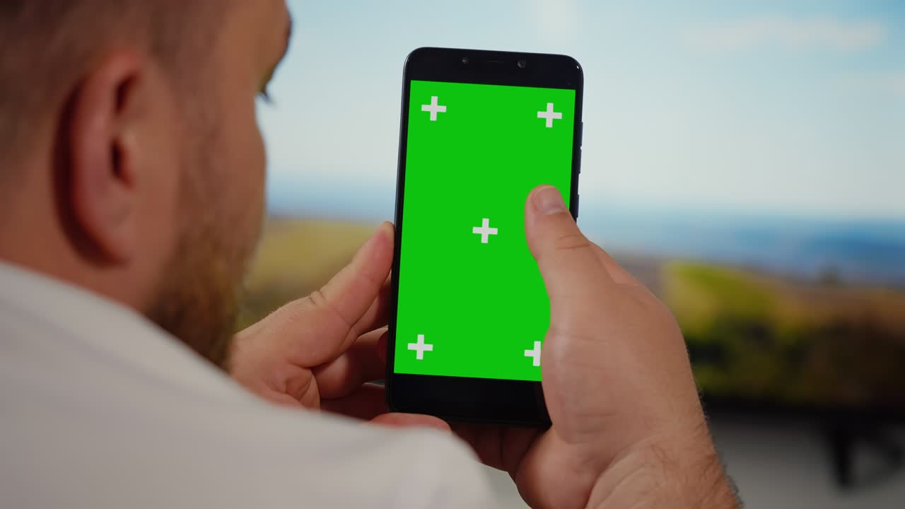Man Using Smartphone with Green Screen.