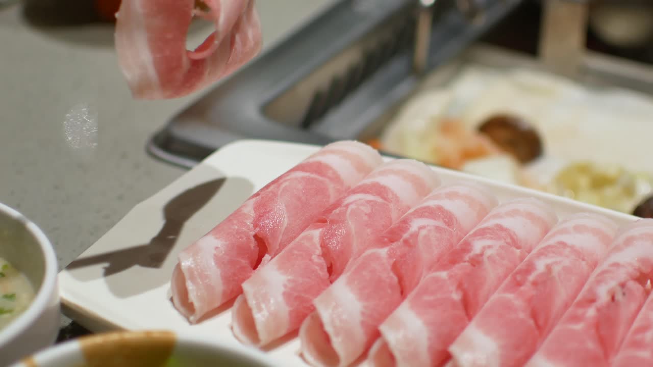 POV to the sliced pork while preparing to cooking shabu hotpot Chinese food style