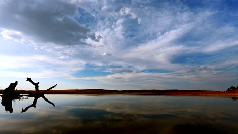 time-lapse of sunset clouds over water hole in africa, sun set time