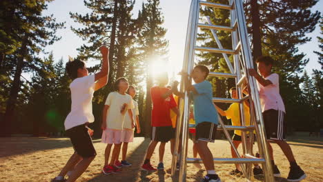 children playing on a metal structure in a sunny park