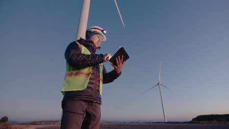 engineer using digital tablet at wind power station