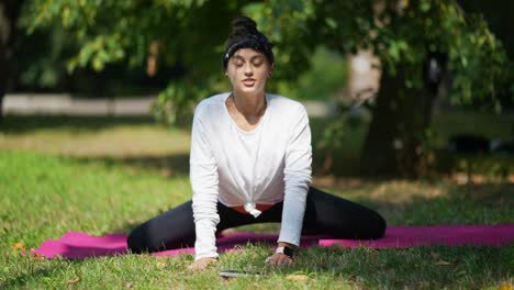 woman practicing yoga in a park