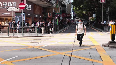 vehicles and pedestrians at a bustling intersection