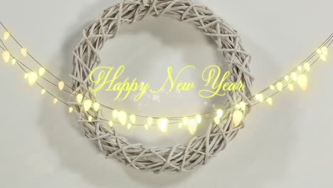 Animation-of-happy-new-year-greetings-text-with-glowing-fairy-lights-and-decoration