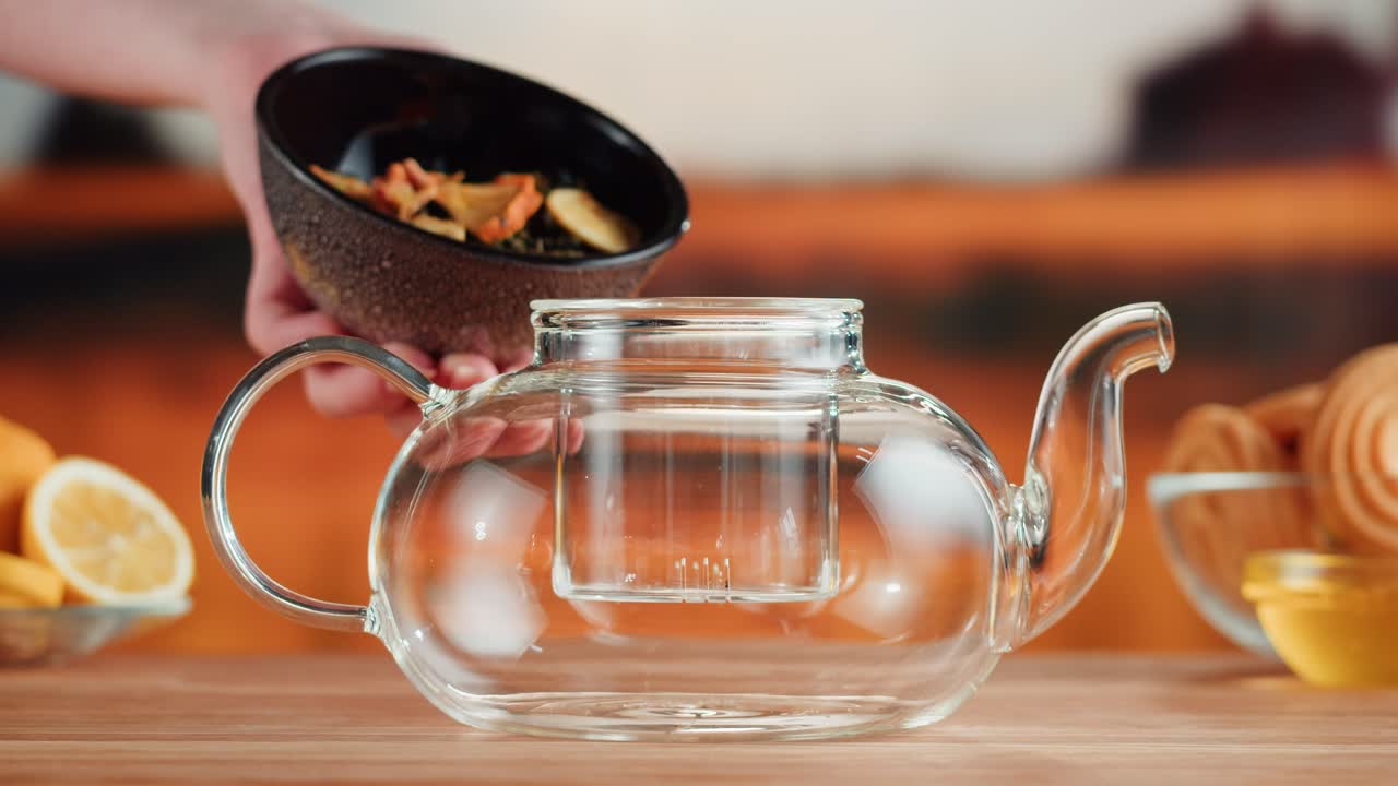 Preparing Herbal Tea in a Glass Teapot