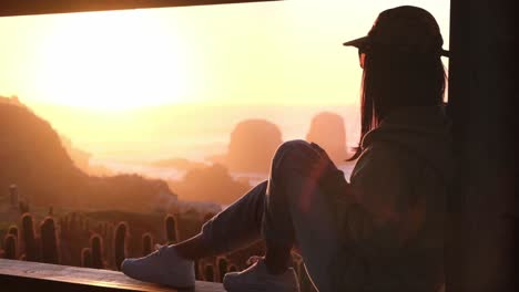 Beautiful-epic-sunset,-with-female-model-looking-at-the-horizon-with-her-marked-silhouette,-looking-at-pichilemu,-punta-de-lobos,-surf-beach