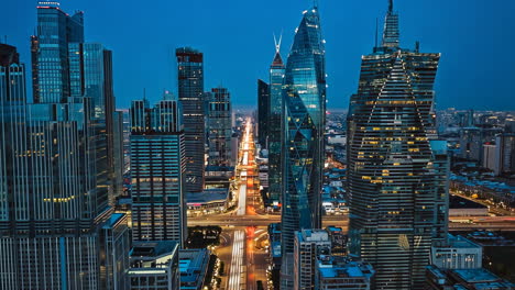 modern cityscape at night with skyscrapers and traffic trails