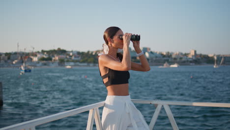 woman with binoculars on a boat