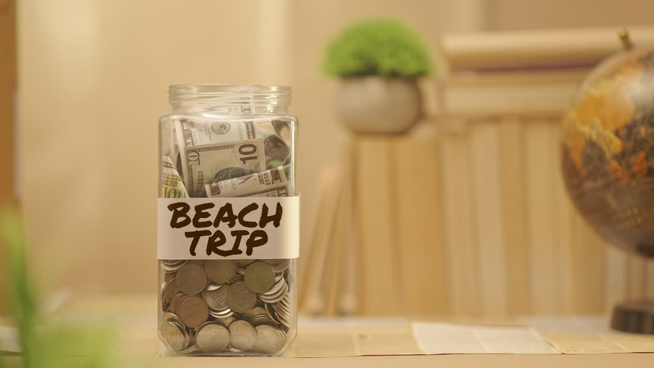 PERSON SAVING MONEY FOR BEACH TRIP