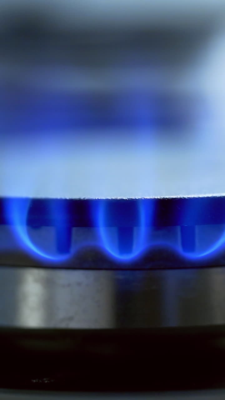 Burning the gas on the stove. Close up shot of fire from gas kitchen stove