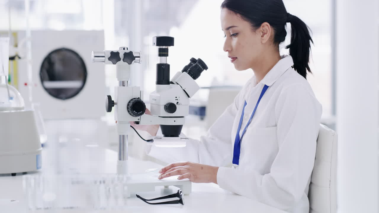 Scientist using a microscope in a laboratory