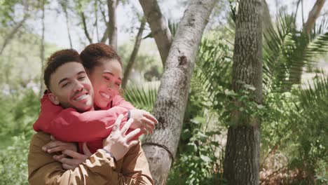 Portrait-of-happy-african-american-couple-embracing-in-forest,-copy-space,-slow-motion