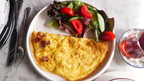 turkish breakfast with omelette, salad and tea