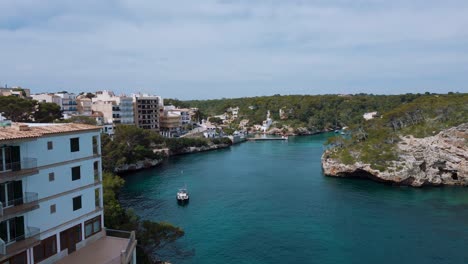 Marina-with-blue-turquoise-clear-sea-water,-sailing-ships-boats-and-hotels,-Palma-de-Mallorca-Island