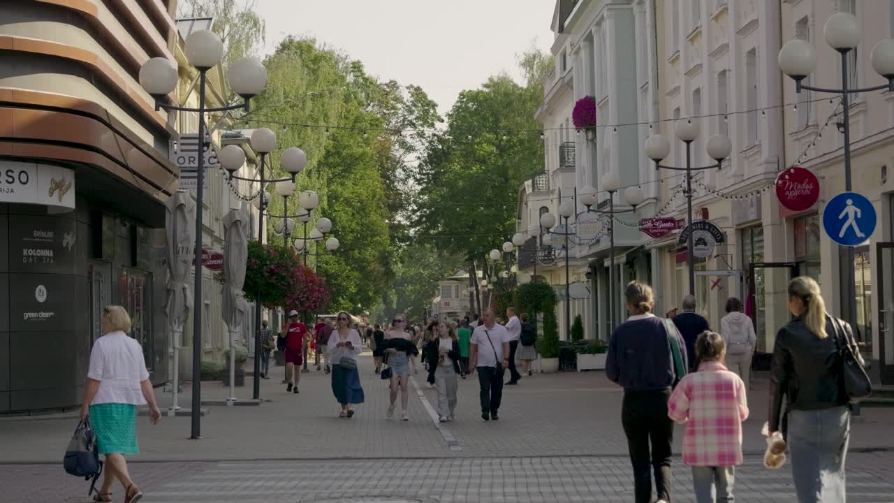 People walking along main promenade of Jurmala resort town on fall day