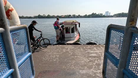 passengers boarding and leaving a small ferry boat