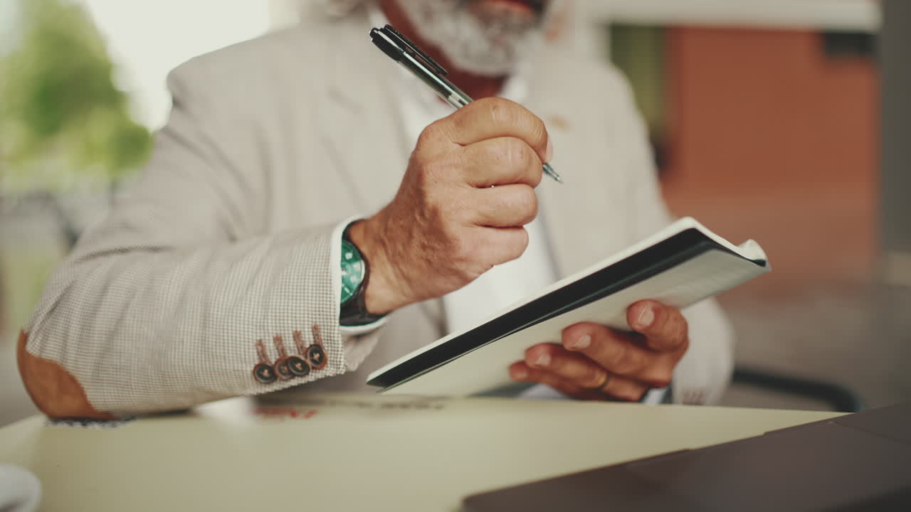 Man writing in notebook