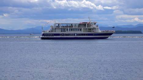 a riverboat loaded with tourists moves out of harbor