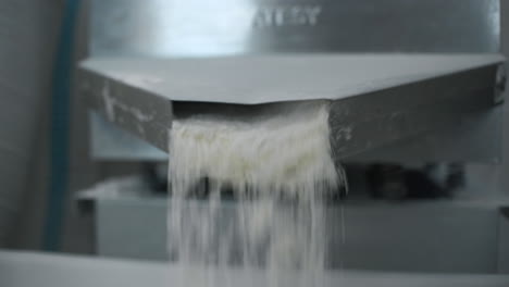 powder flowing from a conveyor system in a factory
