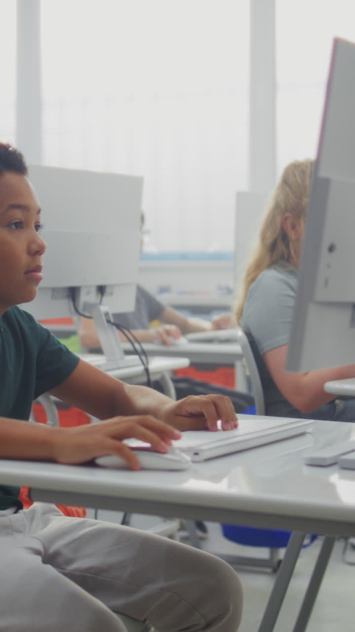 Primary School Students Working on Creative Projects on Computers Studying Programming