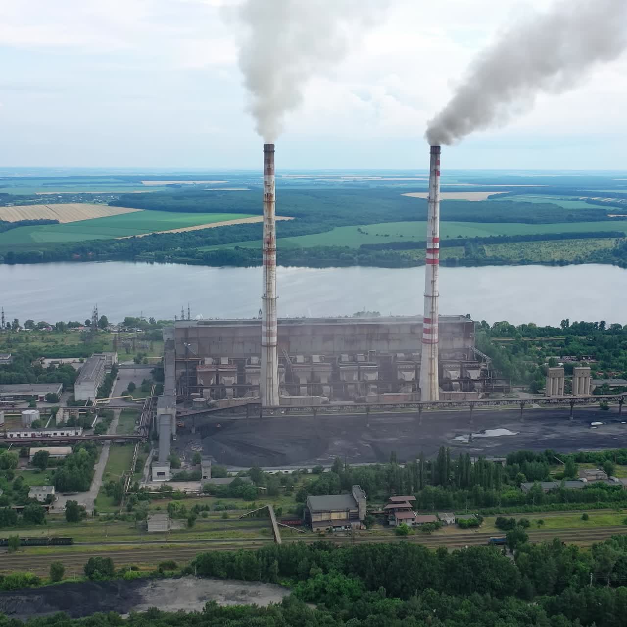 Industrial architecture factory warehouses. Aerial view of big factory territory with huge tubes