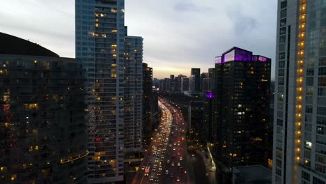 Drone-flying-over-the-Gardiner-Expressway-at-twilight-in-downtown-Toronto