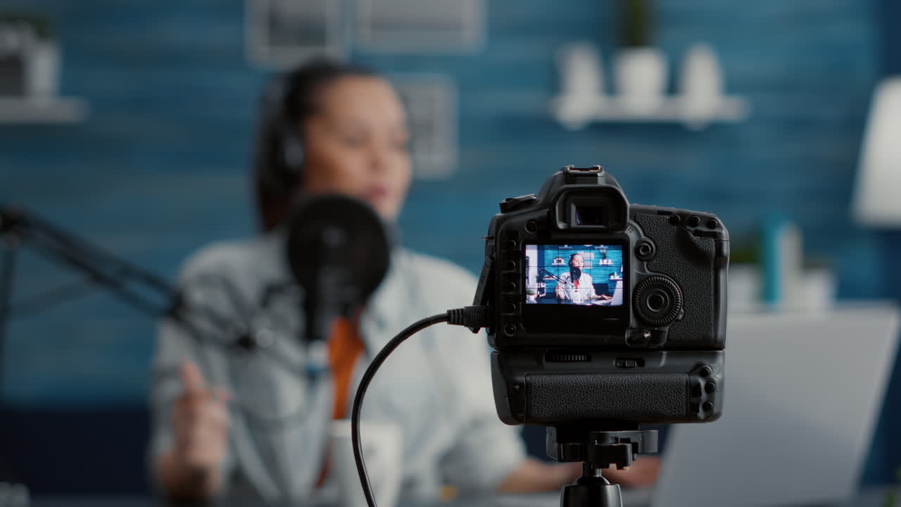 Close up shoot of professional camera recording vlogger talking to audience