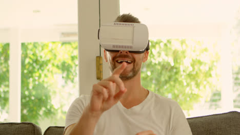 Man-using-virtual-reality-headset-on-sofa-4k