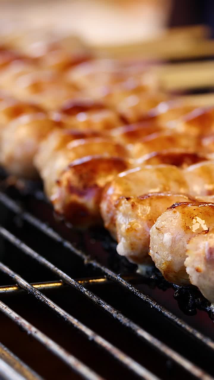 Sausages being grilled on skewers in Bangkok