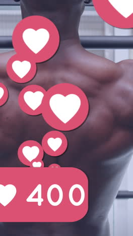 animación de las reacciones de las redes sociales sobre la vista posterior de un hombre afroamericano haciendo ejercicio en el gimnasio