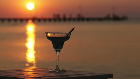 Tropical-cocktail-overlooking-a-sunset-ocean