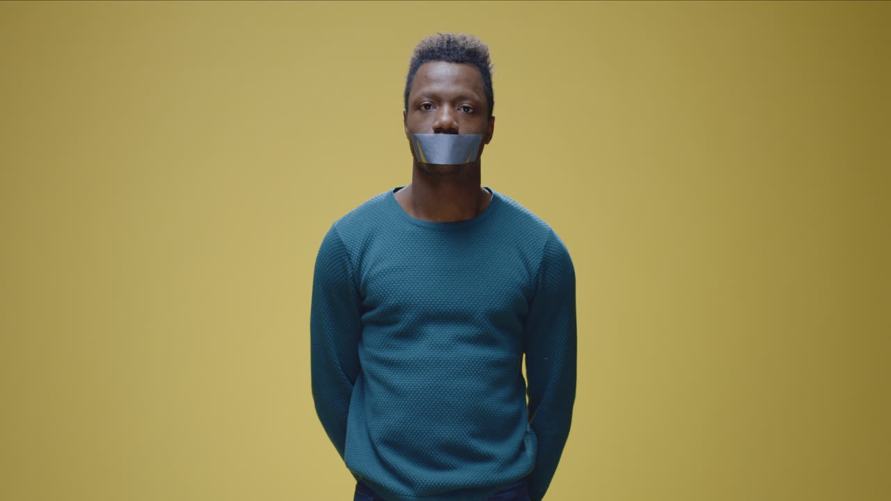 Man with tape over mouth