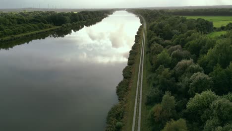 relaxing aerial shot over the water canal with nice sun behind clouds