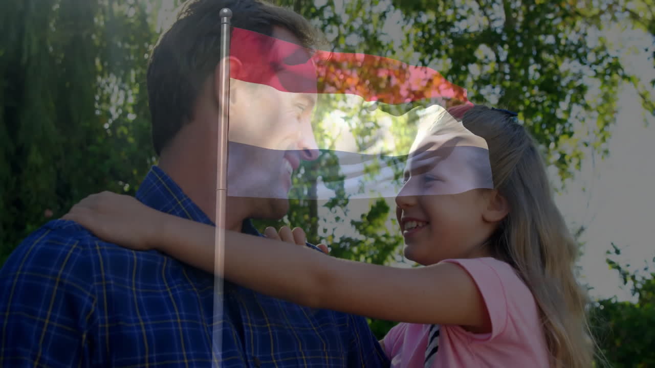 In sunny garden, father and daughter smiling with Dutch flag animation overlay