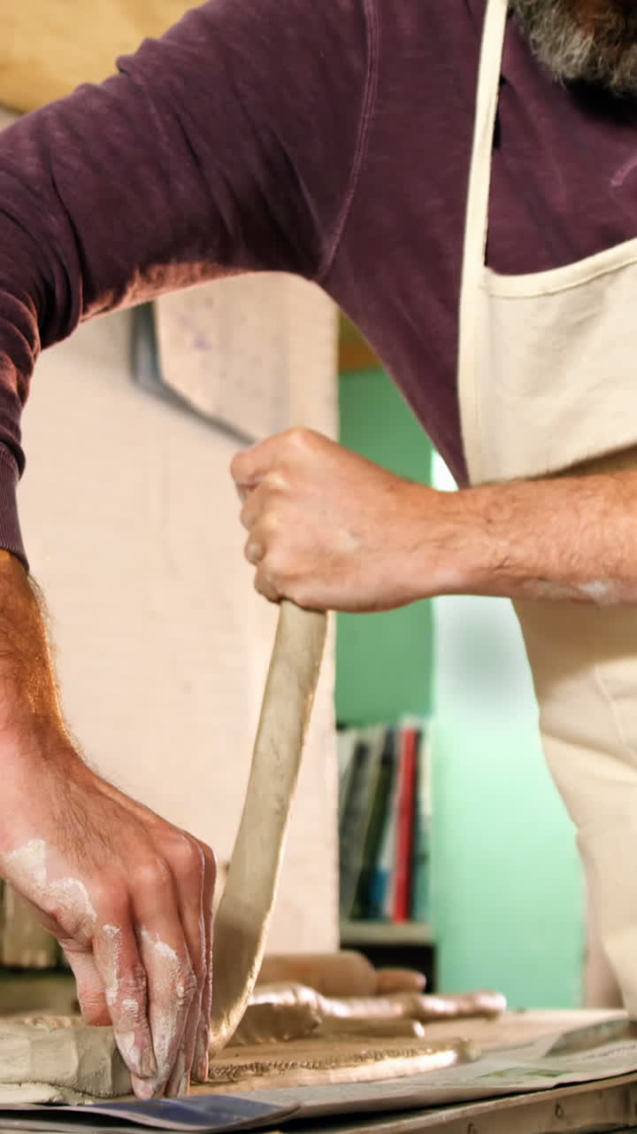 Male potter molding clay