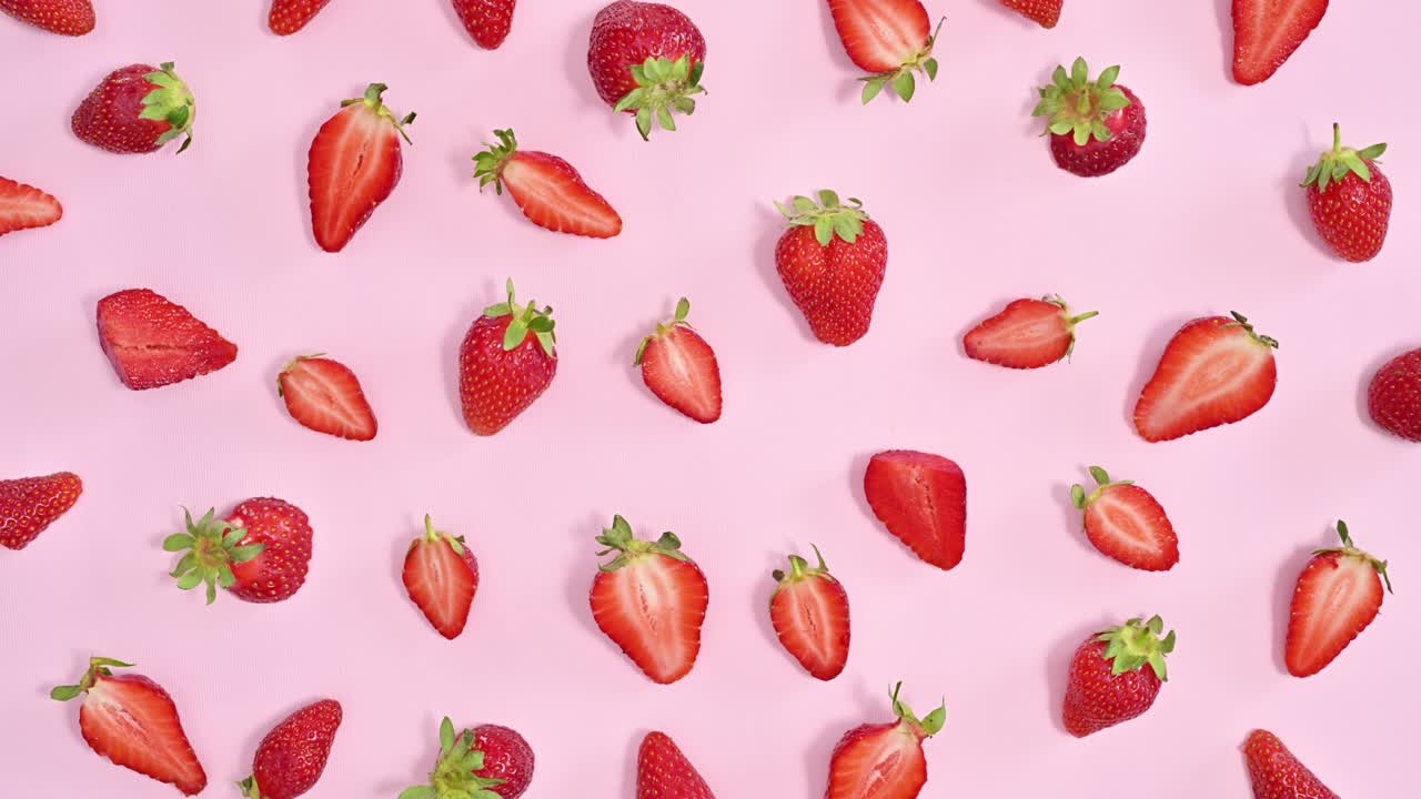 Ripe fresh organic strawberries pattern on pastel pink background. Stop motion flat lay
