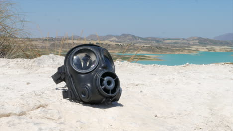 post apocalyptic desert with a discarded gas mask