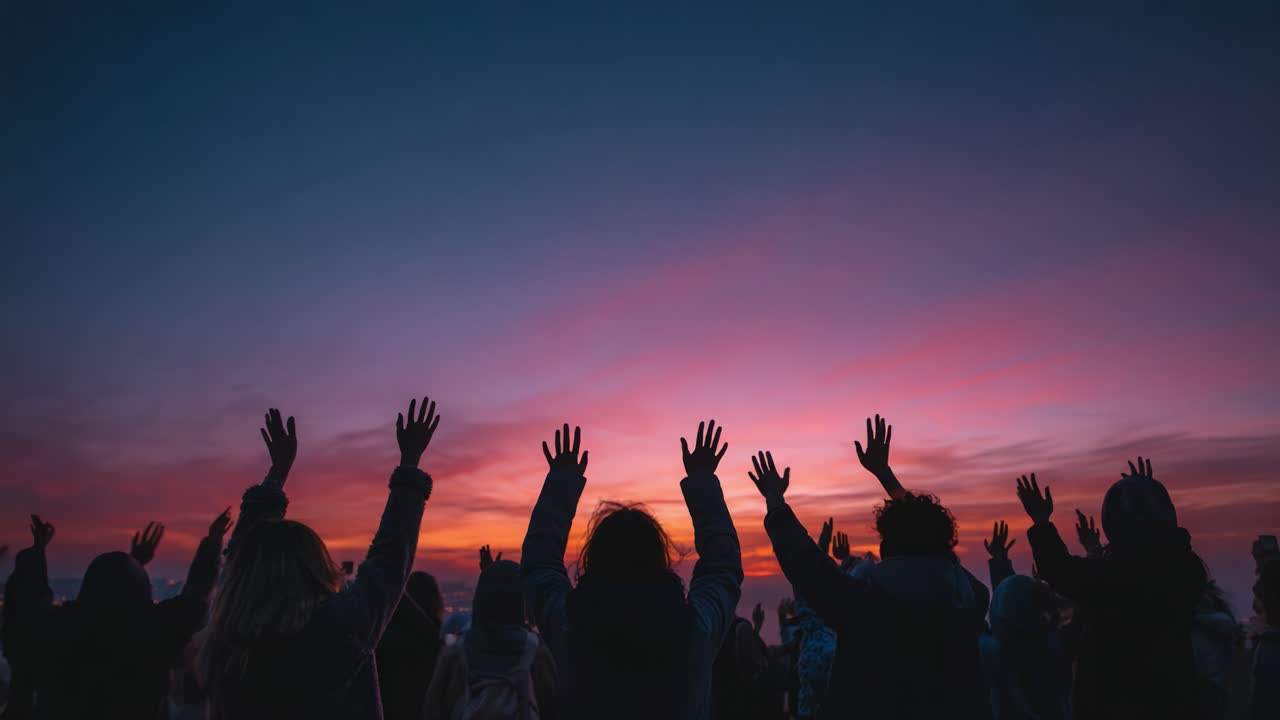 A Collective Expression of Freedom: Silhouettes with Upraised Arms Against a Stunning Sunset Sky Embodying Unity, Hope, and Connection