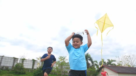 children running and flying a kite