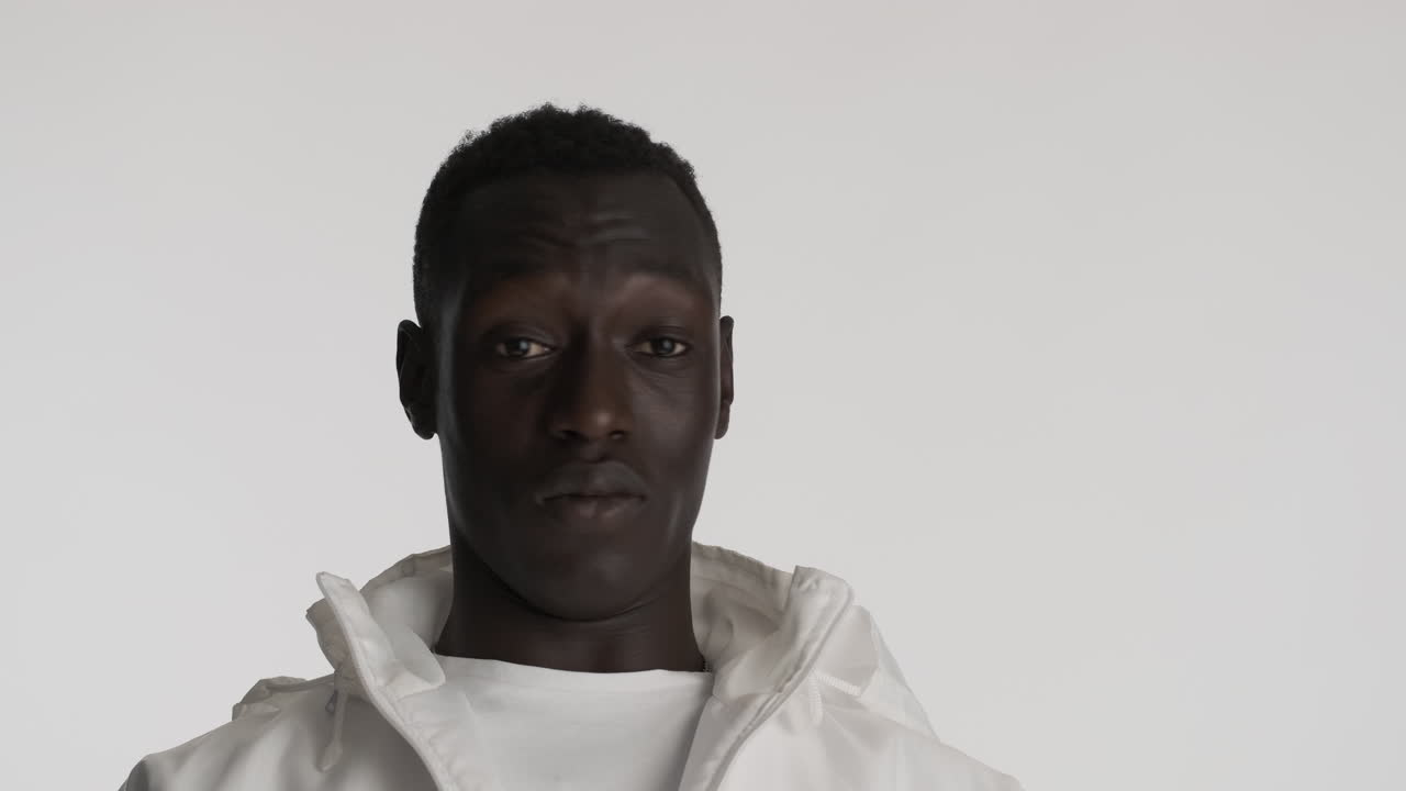 Surprised african american man on grey background.