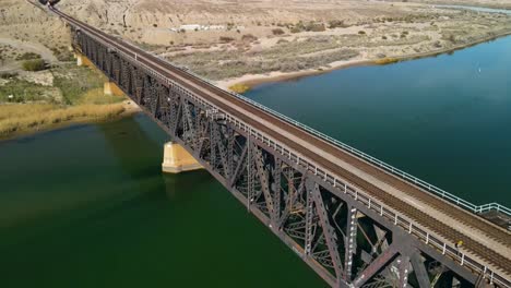 large steel bridge crossing over the colorado river, i-40 freeway east, establshing aerial shot