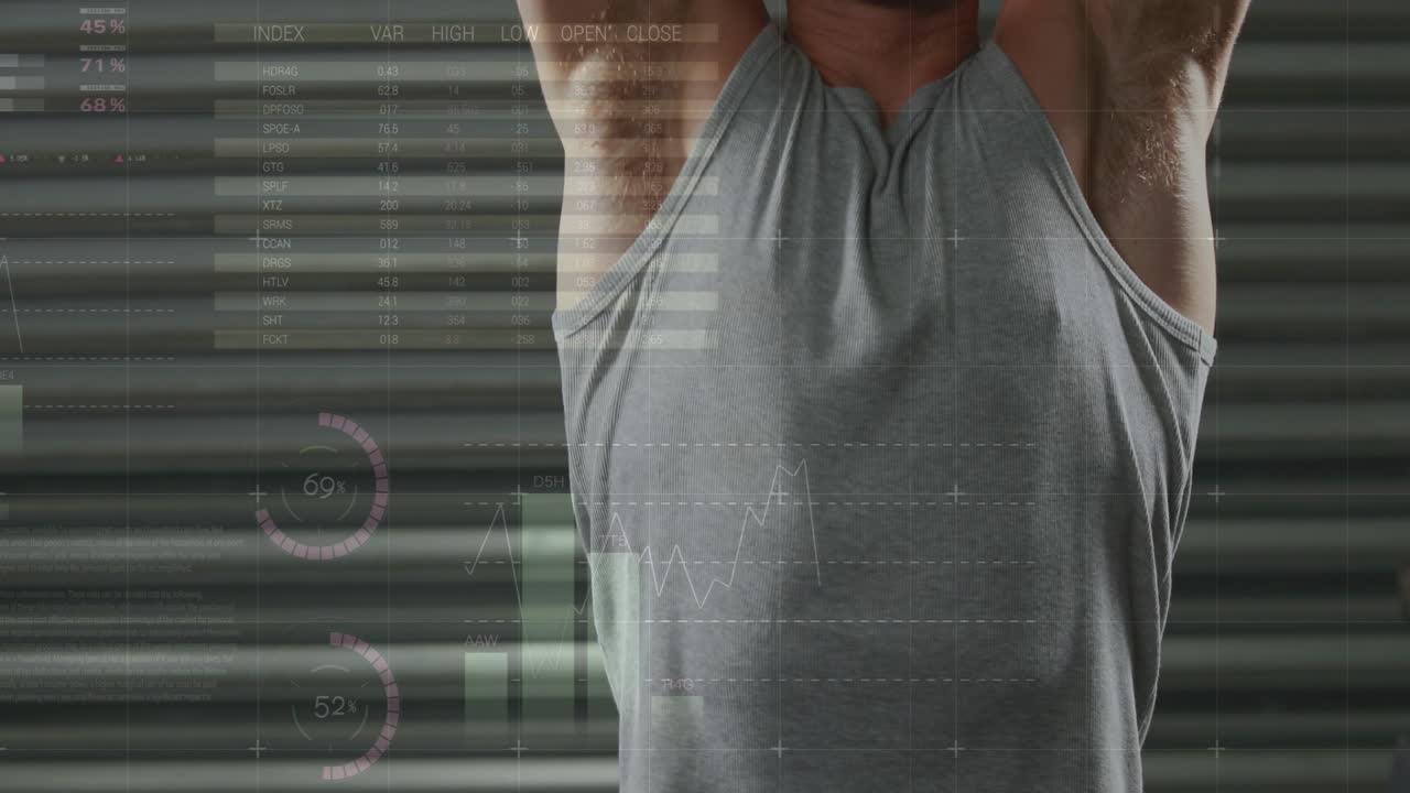 Male athlete positioning kettlebells at shoulders, pressing overhead while fitness charts tracking