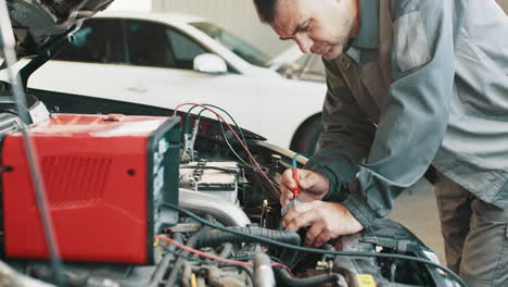 auto mechanic checking car engine