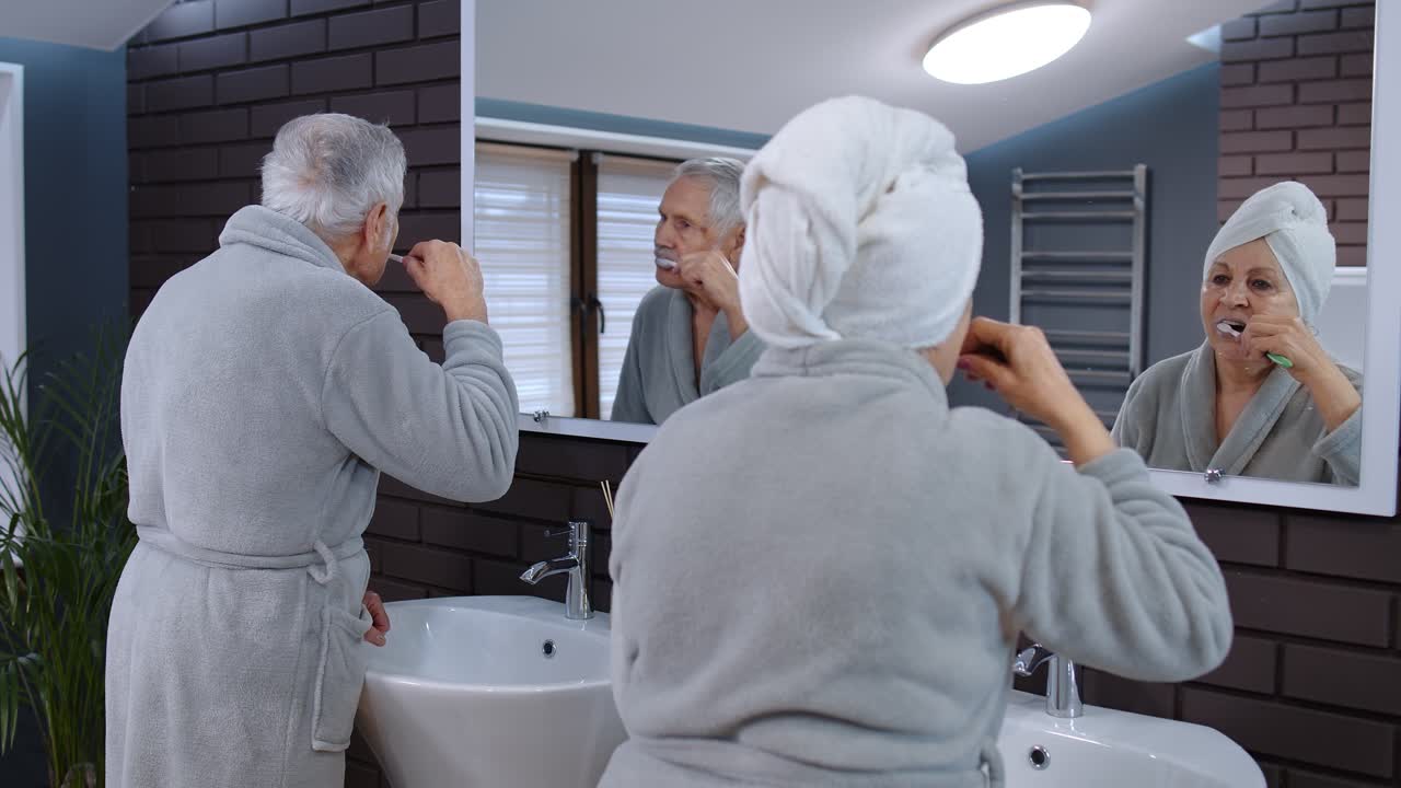Elderly Couple Brushing Their Teeth in the Bathroom