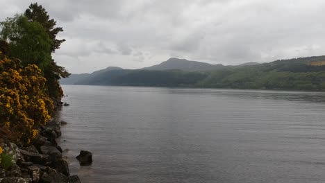 push-out drone shot of remote scottish lakeside