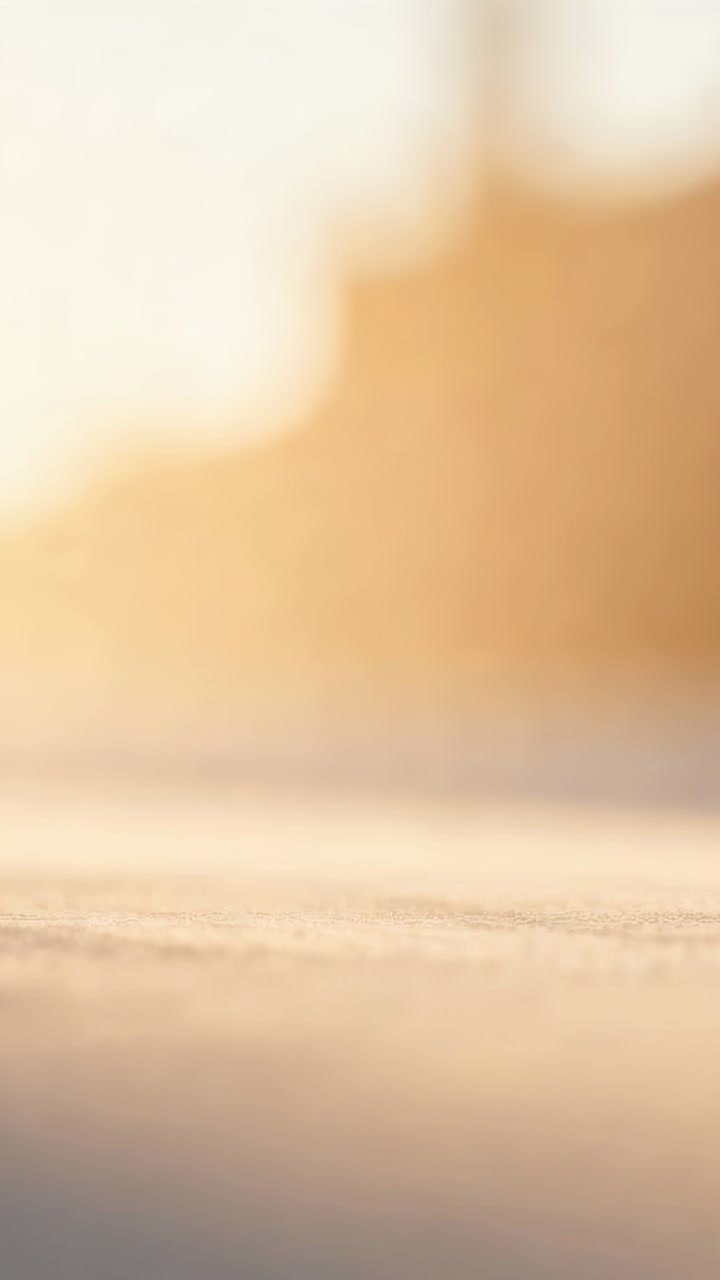 Vertical video: Showing sand staying sharp at ground-level, with low sun showing grain and blur